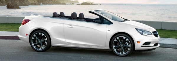 2019 Buick Cascada in white parked next to the ocean with its convertible top down
